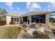 Wide angle view of the backyard showing the patio, lanai, and landscaping at 9651 Se 137Th Street Rd, Summerfield, FL 34491