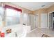 Bathroom with glass enclosed shower, garden tub, and tile flooring at 9651 Se 137Th Street Rd, Summerfield, FL 34491