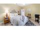 Bedroom with white and gold bedding and a view to the doorway at 9651 Se 137Th Street Rd, Summerfield, FL 34491