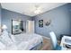 Bedroom with blue walls and view through the doorway at 9651 Se 137Th Street Rd, Summerfield, FL 34491