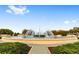 Beautiful fountain with water jets under a blue sky surrounded by manicured greenery and elegant landscaping at 9651 Se 137Th Street Rd, Summerfield, FL 34491