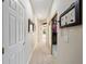 Hallway with decorative mirror and views into the walk-in closet and back lanai at 9651 Se 137Th Street Rd, Summerfield, FL 34491