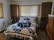 Bedroom with double bed, built-in cabinets, and window at 11256 Sw 78Th Ave, Ocala, FL 34476