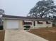 Ranch-style home with attached garage and landscaping at 11256 Sw 78Th Ave, Ocala, FL 34476