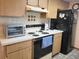Kitchen boasts wood cabinets and a built-in oven at 11256 Sw 78Th Ave, Ocala, FL 34476