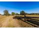 Long private driveway leading to home with pasture and fence at 11435 S Em En El Grove Rd, Leesburg, FL 34788