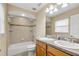 Bathroom with double vanity, bathtub, and tiled walls at 12854 Se 118Th Ter, Ocklawaha, FL 32179
