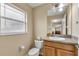 Clean bathroom with vanity, toilet, and window at 12854 Se 118Th Ter, Ocklawaha, FL 32179