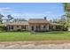 House exterior showcasing a well-maintained lawn and front porch at 12854 Se 118Th Ter, Ocklawaha, FL 32179