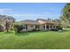 Charming single story home with lush lawn, manicured landscaping and inviting covered porch at 12854 Se 118Th Ter, Ocklawaha, FL 32179