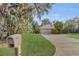 House exterior showcasing a well-maintained lawn and driveway at 12854 Se 118Th Ter, Ocklawaha, FL 32179