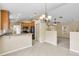 Open-concept kitchen featuring tile floors, wood cabinets, and black appliances at 12854 Se 118Th Ter, Ocklawaha, FL 32179