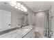 Updated bathroom, granite countertop, and a bathtub at 1302 Ne 22Nd Ave, Ocala, FL 34470
