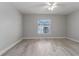 Well-lit bedroom featuring wood-look floors and a window at 1302 Ne 22Nd Ave, Ocala, FL 34470