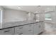 Kitchen island with granite countertop and white cabinets at 1302 Ne 22Nd Ave, Ocala, FL 34470