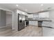 Modern kitchen with white cabinets, granite counters, and stainless steel appliances at 1302 Ne 22Nd Ave, Ocala, FL 34470