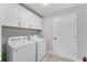 Bright laundry room with washer, dryer, and ample cabinet space at 1302 Ne 22Nd Ave, Ocala, FL 34470