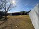 View of home's back and side yard with grassy area and trees at 15083 Sw 43Rd Terrace Rd, Ocala, FL 34473