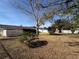 Large backyard with mature trees, grass, and a white vinyl fence at 15083 Sw 43Rd Terrace Rd, Ocala, FL 34473