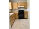 Galley kitchen with wood cabinets and black appliances at 15083 Sw 43Rd Terrace Rd, Ocala, FL 34473