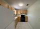 Galley kitchen with wood cabinets and white appliances at 15083 Sw 43Rd Terrace Rd, Ocala, FL 34473