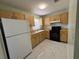 Galley kitchen with wood cabinets and white appliances at 15083 Sw 43Rd Terrace Rd, Ocala, FL 34473