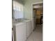 Laundry room with washer, dryer, and kitchen view at 15083 Sw 43Rd Terrace Rd, Ocala, FL 34473