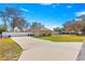 House with a large yard and a long driveway at 15391 Se 90Th Ct, Summerfield, FL 34491