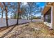 Side yard view with a white vinyl fence and mature trees at 15391 Se 90Th Ct, Summerfield, FL 34491