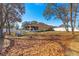 Backyard view of house with screened porch and mature trees at 15391 Se 90Th Ct, Summerfield, FL 34491