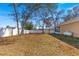 Large backyard with mature trees and a white vinyl fence at 15391 Se 90Th Ct, Summerfield, FL 34491
