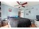 Cozy bedroom with ceiling fan and built-in shelving at 15391 Se 90Th Ct, Summerfield, FL 34491