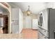 Kitchen features white cabinets, pantry, and stainless steel refrigerator at 15391 Se 90Th Ct, Summerfield, FL 34491