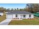 Newly built home with a gray roof and landscaped lawn at 15482 Sw 10 Pl, Ocala, FL 34481