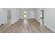 Open concept living room with light walls and wood-look floors at 15482 Sw 10 Pl, Ocala, FL 34481