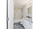 Bathroom with white marble tiled shower, granite countertops, and modern fixtures at 15982 Sw 30 Ln, Ocala, FL 34481