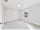 Spacious bedroom with grey carpet and a large window at 15982 Sw 30 Ln, Ocala, FL 34481