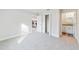 Spacious bedroom with plush carpet and a closet, leading to the bathroom and kitchen at 15982 Sw 30 Ln, Ocala, FL 34481