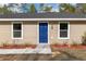 Inviting front entrance features a bright blue door flanked by white-trimmed windows at 15982 Sw 30 Ln, Ocala, FL 34481