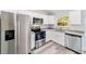 Bright kitchen with stainless steel appliances, granite countertops, and white cabinets at 15982 Sw 30 Ln, Ocala, FL 34481