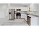 Modern kitchen with stainless steel appliances, white cabinets, and granite countertops at 15982 Sw 30 Ln, Ocala, FL 34481