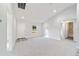 Bright living room with grey carpet, high ceilings, and access to kitchen and bathroom at 15982 Sw 30 Ln, Ocala, FL 34481