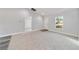Bright living area with a large window and adjacent rooms with wood grain flooring at 15982 Sw 30 Ln, Ocala, FL 34481