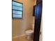 Bathroom with toilet and dark wood cabinet at 1804 Sw 29Th Ter, Ocala, FL 34474