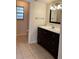 Bathroom featuring a dark wooden vanity and tiled floor at 1804 Sw 29Th Ter, Ocala, FL 34474