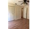 Bedroom with wood-look floors, closet, and ceiling fan at 1804 Sw 29Th Ter, Ocala, FL 34474