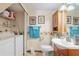 Bathroom featuring a toilet, sink, and a washer/dryer with overhead storage shelves at 2145 Ne 45Th Ave # 2145, Ocala, FL 34470