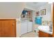 Bathroom featuring a toilet, sink, and a washer/dryer with overhead storage shelves at 2145 Ne 45Th Ave # 2145, Ocala, FL 34470