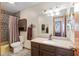 Bathroom features mosaic tile accents, brown cabinets and a framed mirror at 2145 Ne 45Th Ave # 2145, Ocala, FL 34470