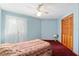 Bedroom featuring light blue walls, plush carpet, and a large window with lace curtains at 2145 Ne 45Th Ave # 2145, Ocala, FL 34470